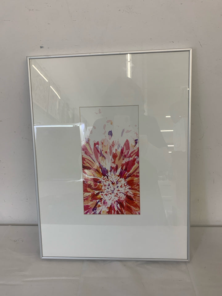 COLORED STARBURST IN WHITE FRAME SILVER TRIM WALL ART.