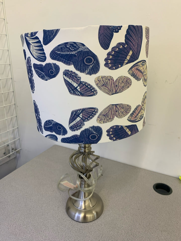 SILVER SWIRL TABLE LAMP WITH WHITE BLUE BUTTERFLY SHADE.