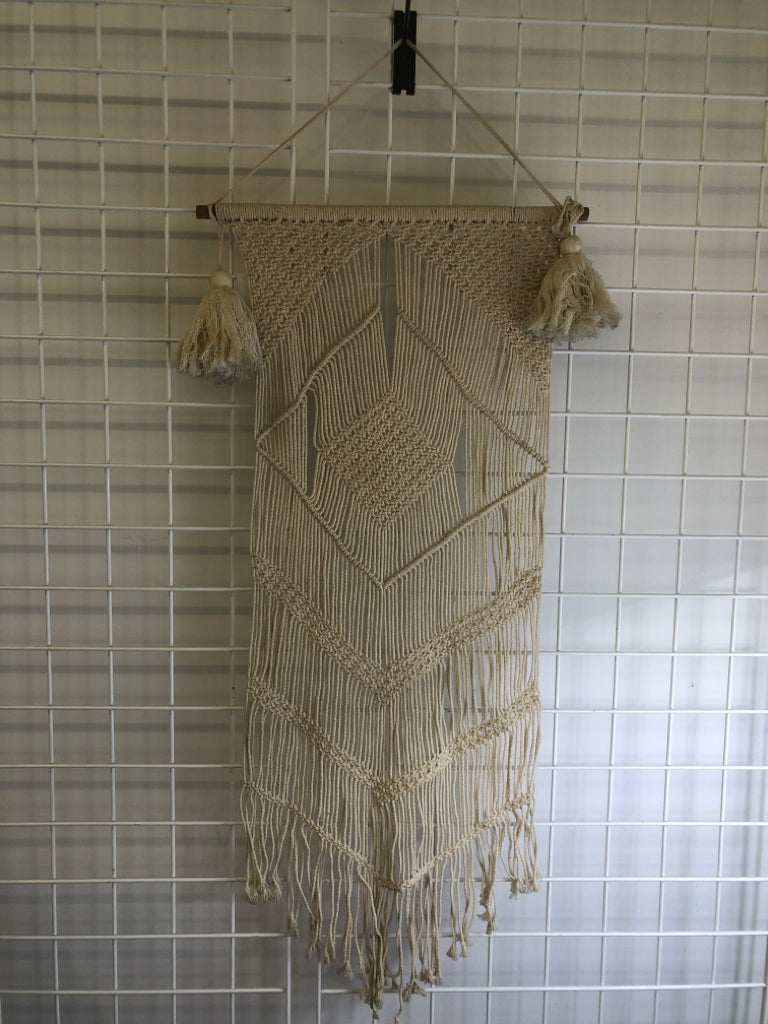 MACRAME WALL HANGING ON DOWEL W/ LARGE TASSELS.