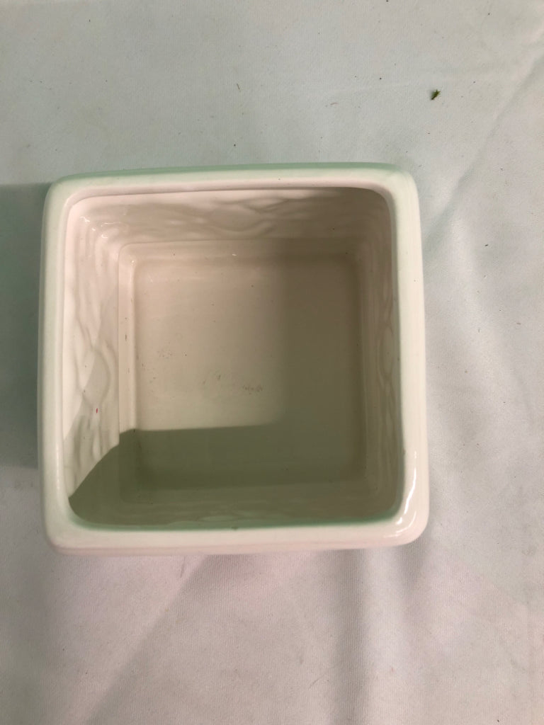 WHITE SQUARE CERAMIC PLANTER W/ EMBOSSED FLOWERS.
