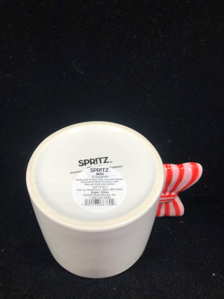 WHITE MUG W/ PINK/RED BOW HANDLE.