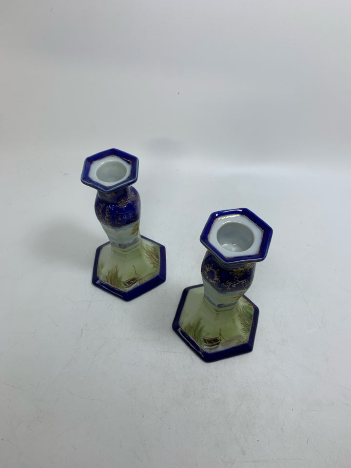2 CERAMIC COBALT BLUE W/ SCENE TAPERED CANDLE HOLDERS.