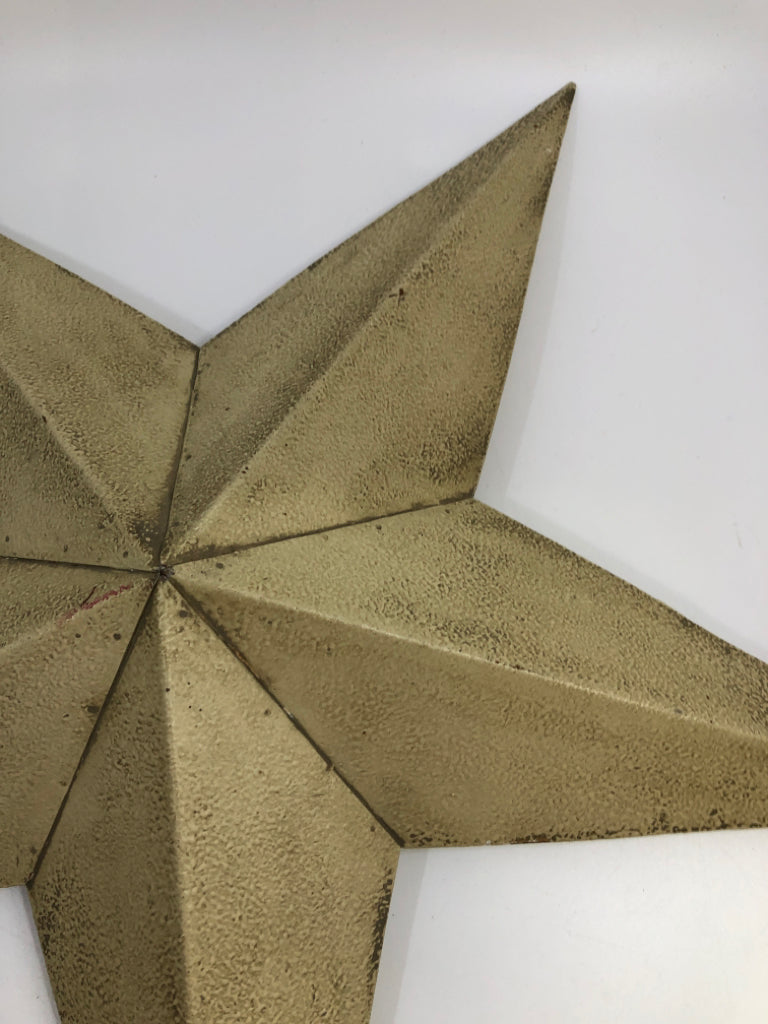 TAN METAL STAR WALL DECOR.