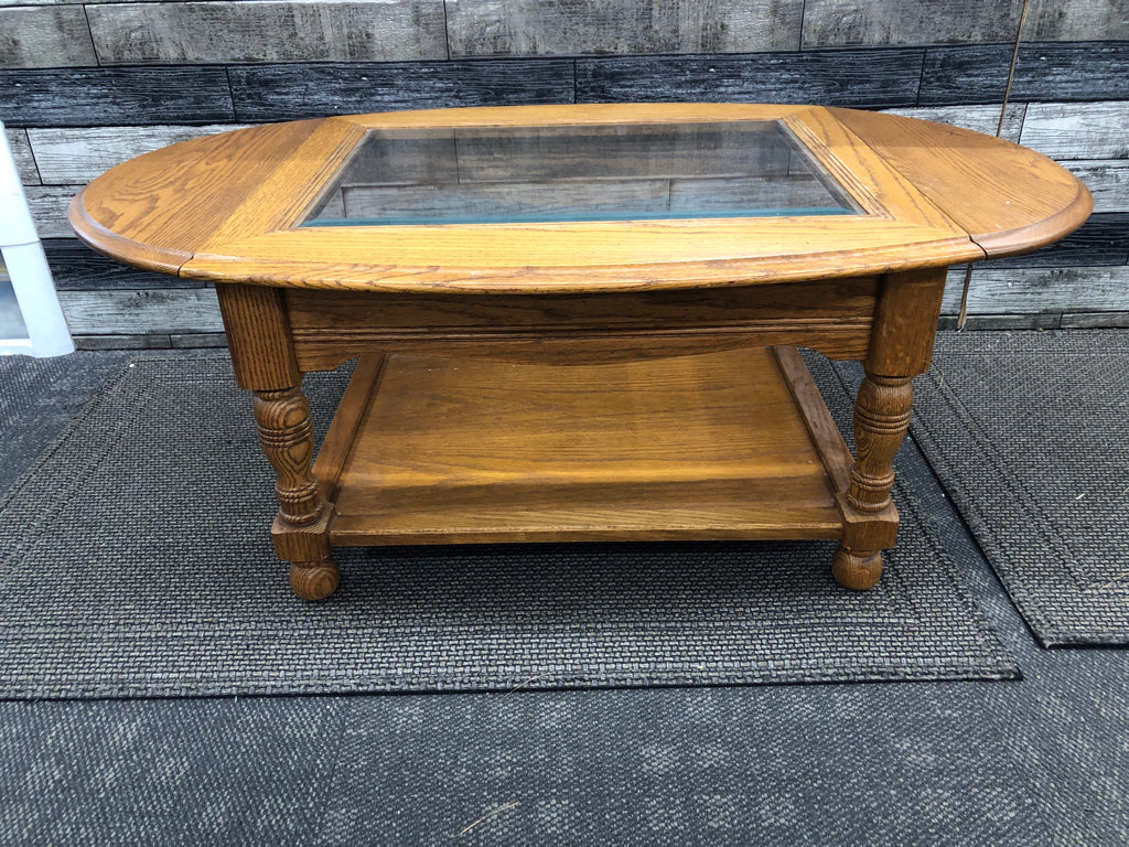 OAK WOOD COFFEE TABLE W/ GLASS TOP/FOLDING SIDES.