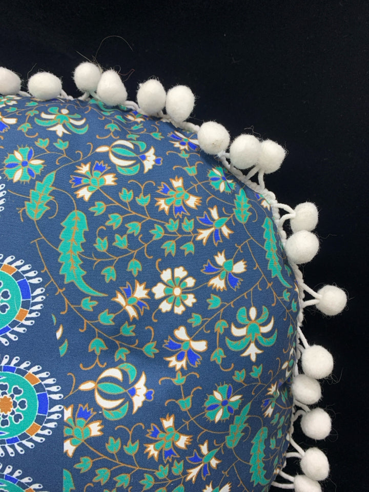 BLUE MEDALLION ACCENT PILLOW W/WHITE POM POMS.