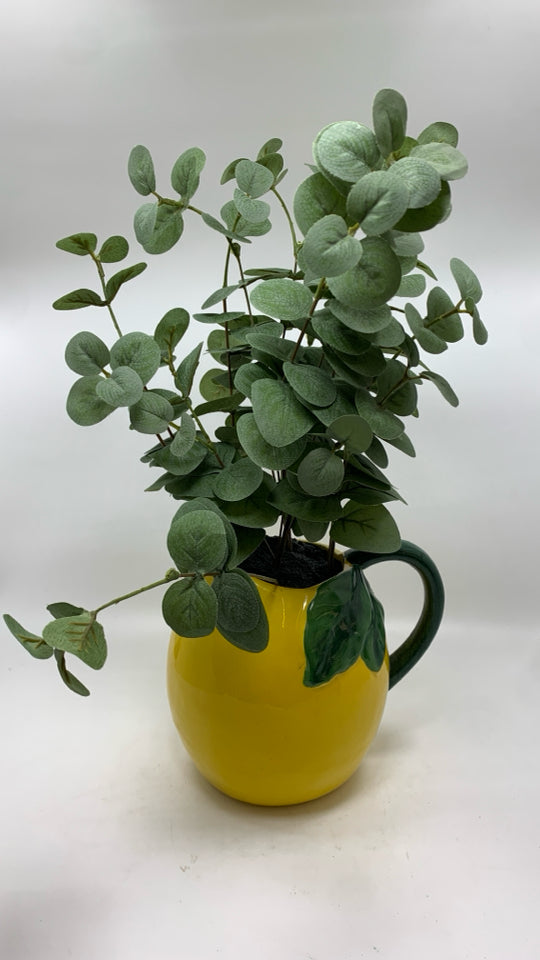 FAUX EUCALYPTUS IN YELLOW CERAMIC PITCHER.