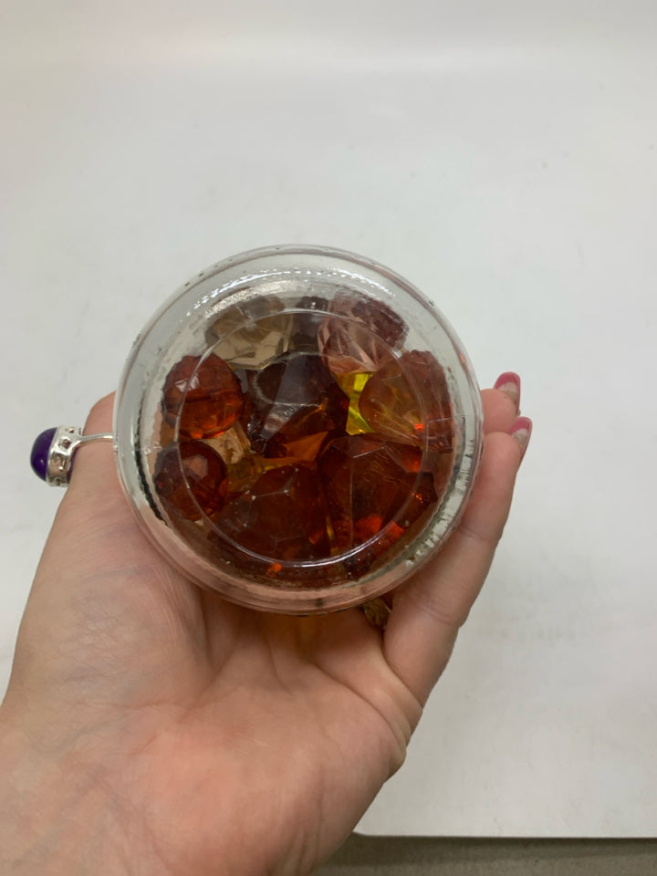 JAR OF PUMPKIN BEADS.