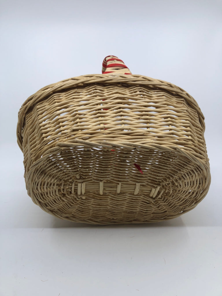 BLONDE WICKER BASKET W/HANDLE AND RED RIBBON.