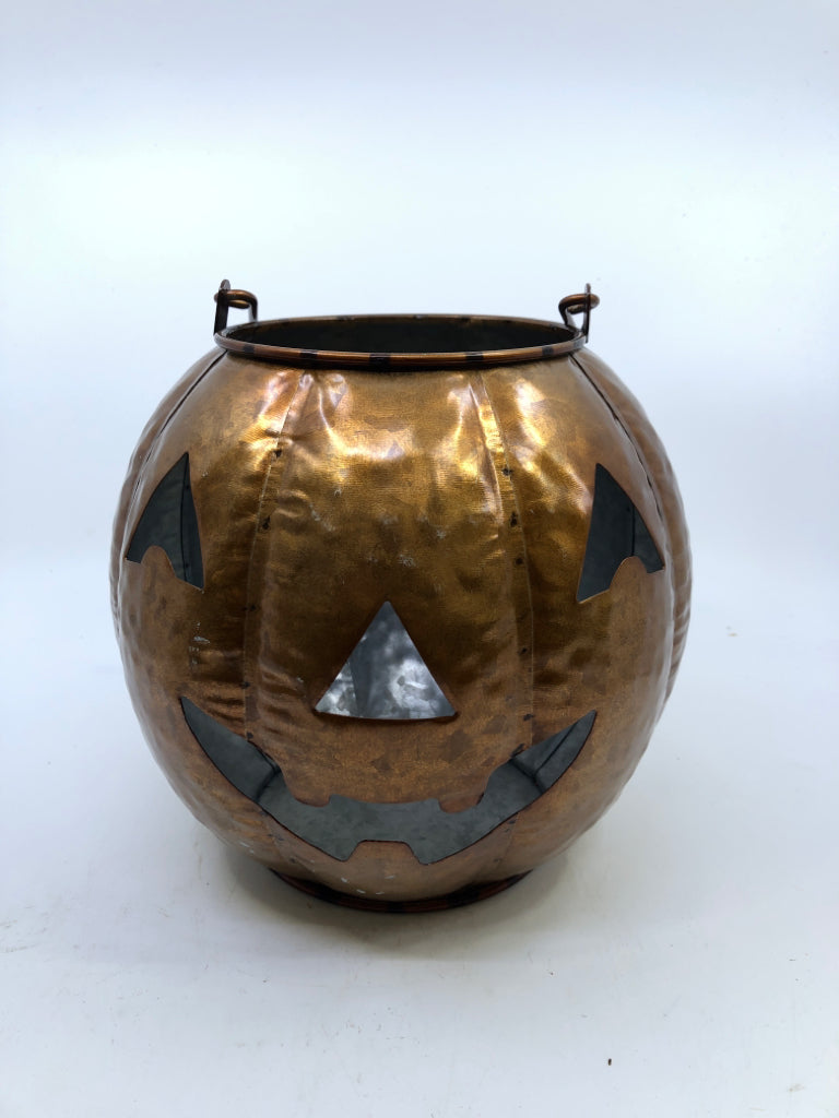 BRONZE JACK O LANTERN CANDLE HOLDER.