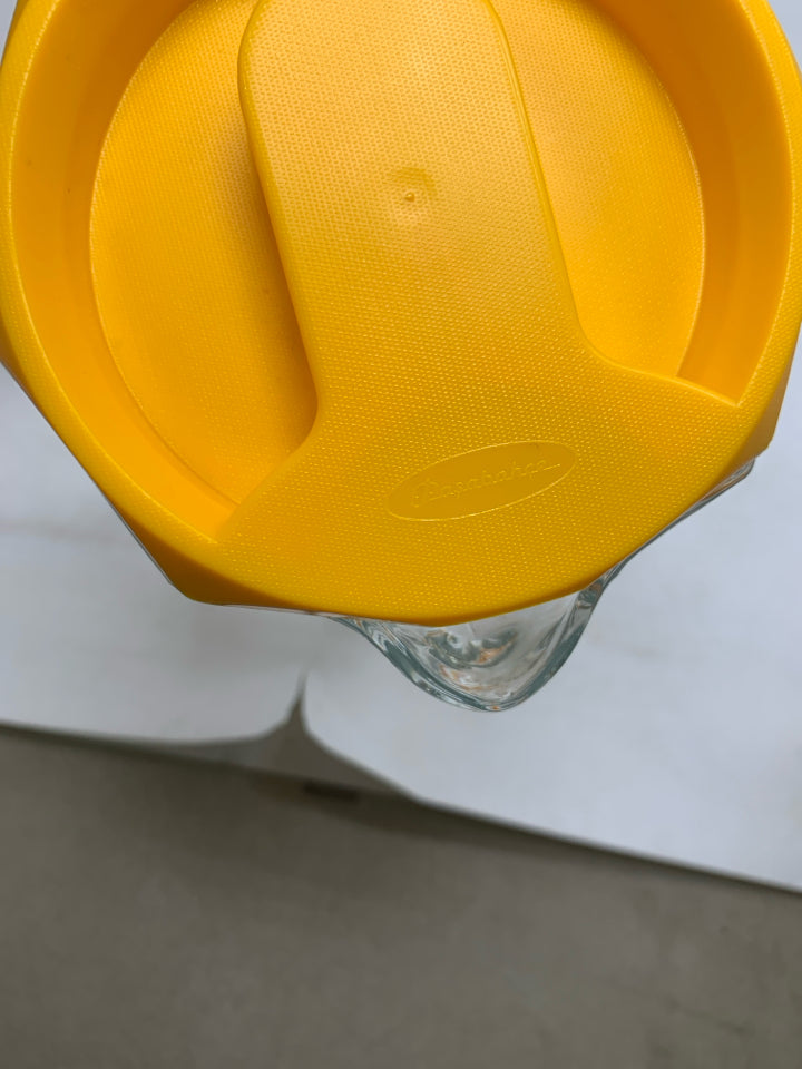 GLASS OCTAGON SHAPE SHAPE PITCHER W/ YELLOW LID.