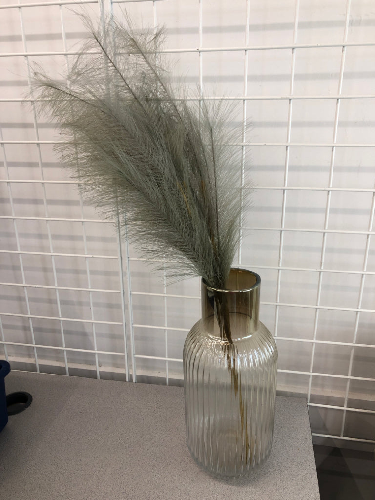 FLUFFY GREEN LEAVES IN GLASS VASE.