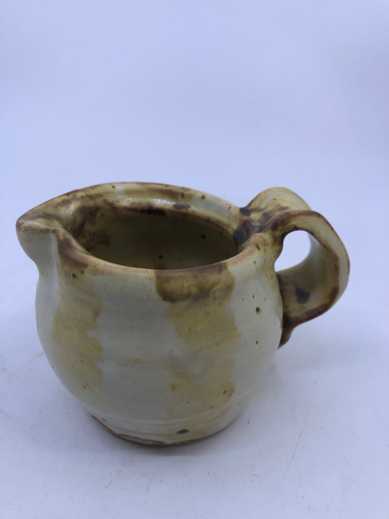 BROWN AND YELLOW COW PATTERN CREAMER.