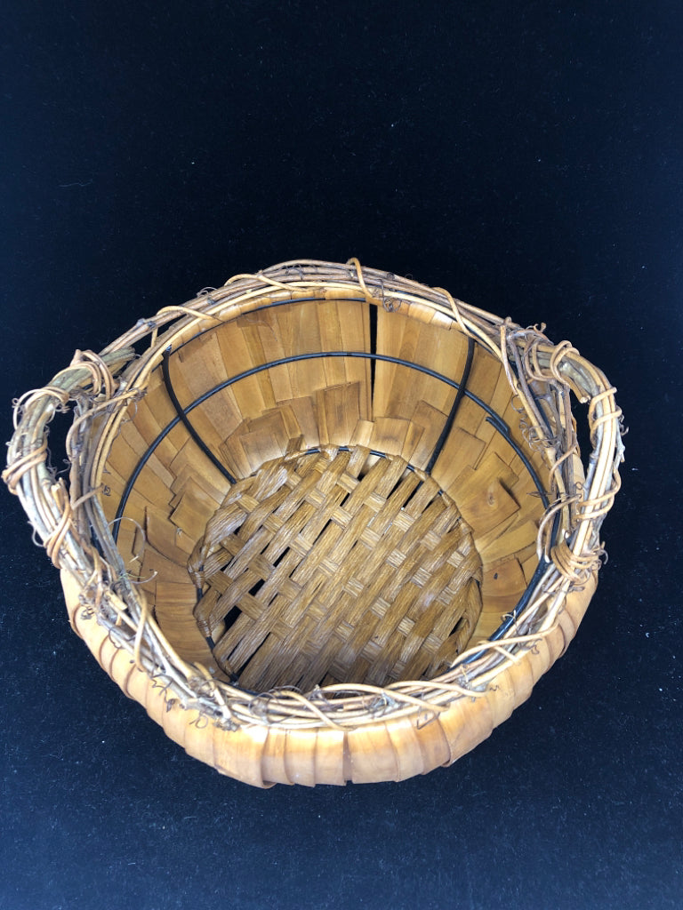 WELL MADE ROUND BASKET W TWIG WRAPPED HANDLES.