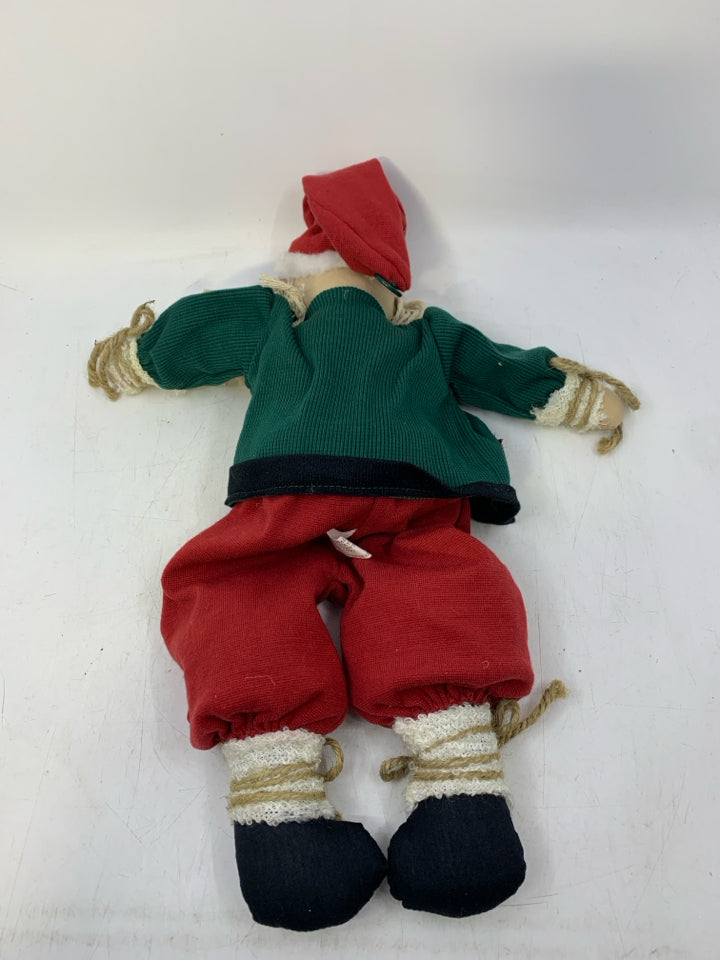 PLUSH PRIMITIVE STYLE SHELF SITTING SANTA GREEN COAT/RED PANTS.