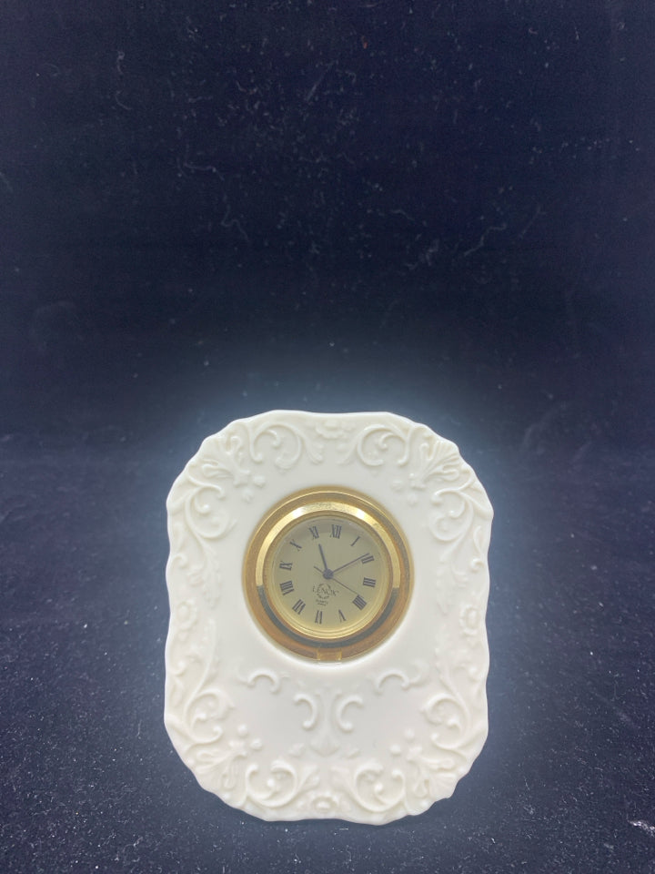 SMALL LENOX STANDING CLOCK W/ EMBOSSED SCROLL PATTERN.