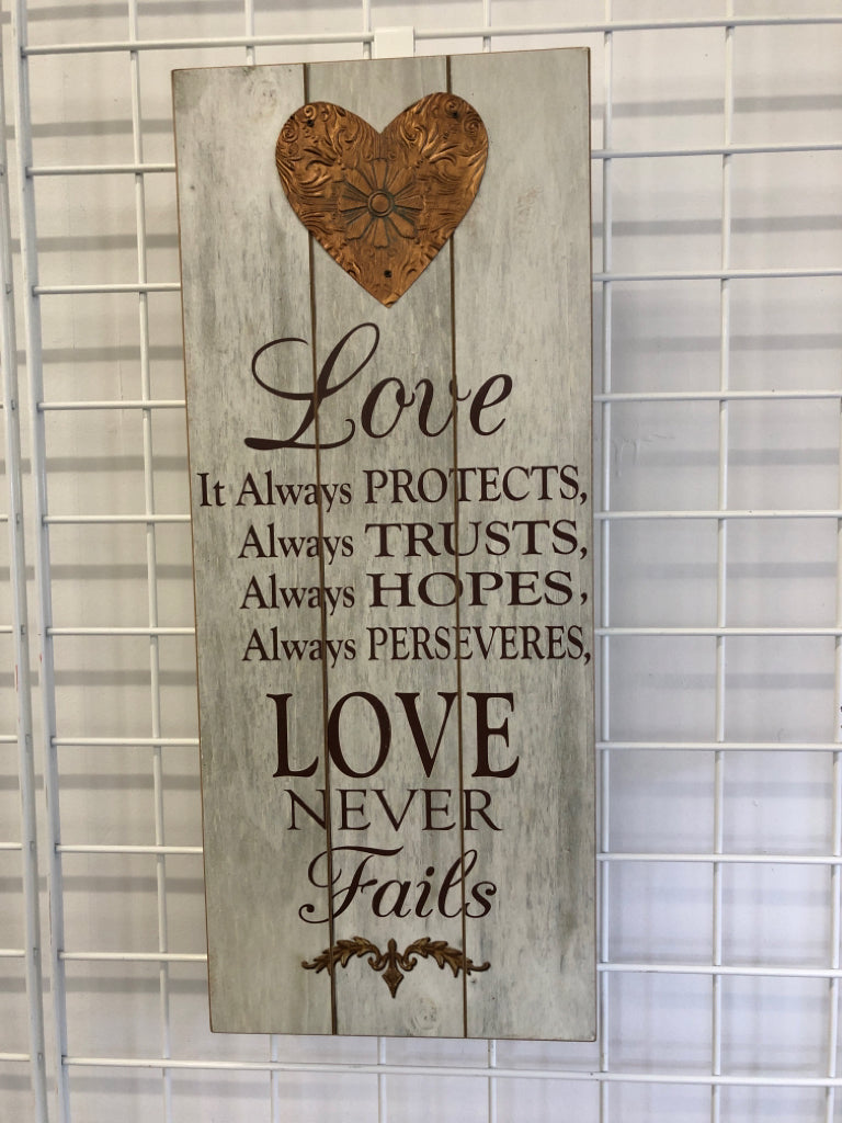 LOVE NEVER FAILS WOOD WALL ART.