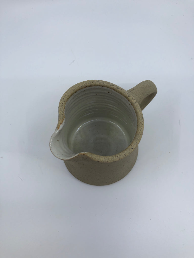 POTTERY PITCHER ROUGH OUTSIDE W/ WHITE GLAZE INSIDE HERITAGE COLLECTION.