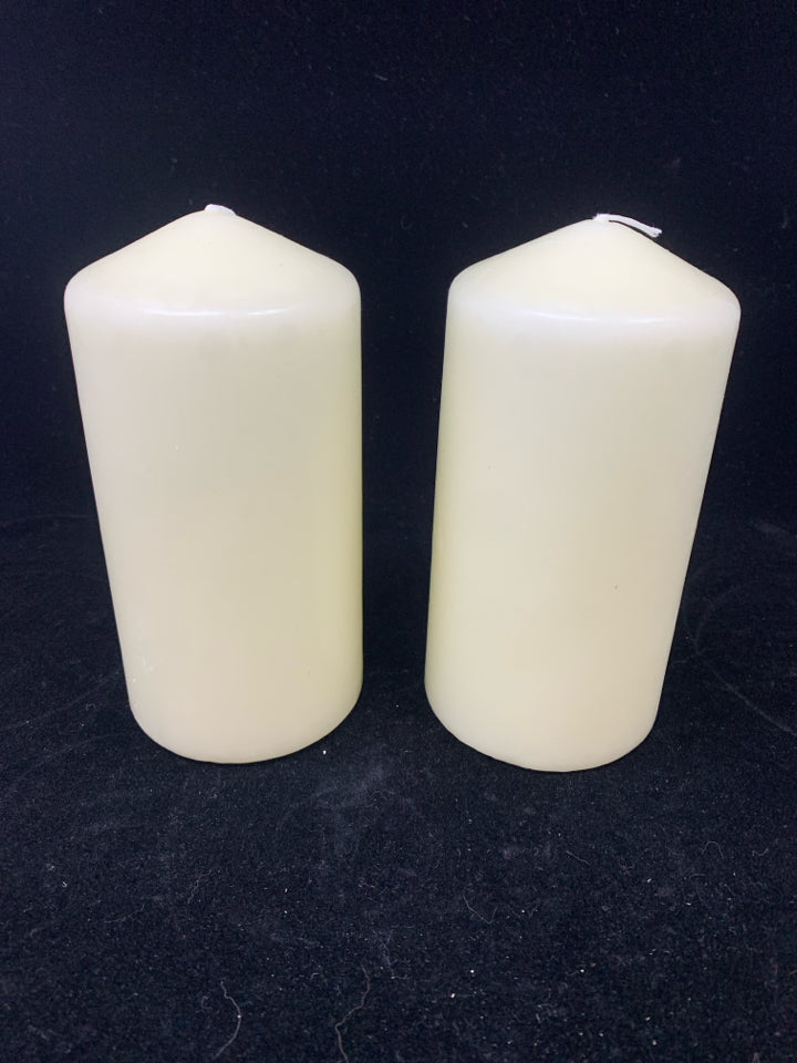2 CREAM PILLAR CANDLES.