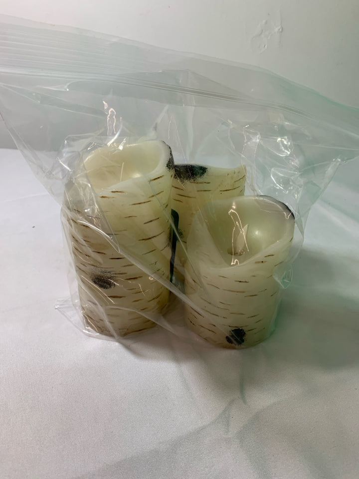 3 WHITE BIRCH WOOD BATTERY OPERATED CANDLES WITH REMOTE.
