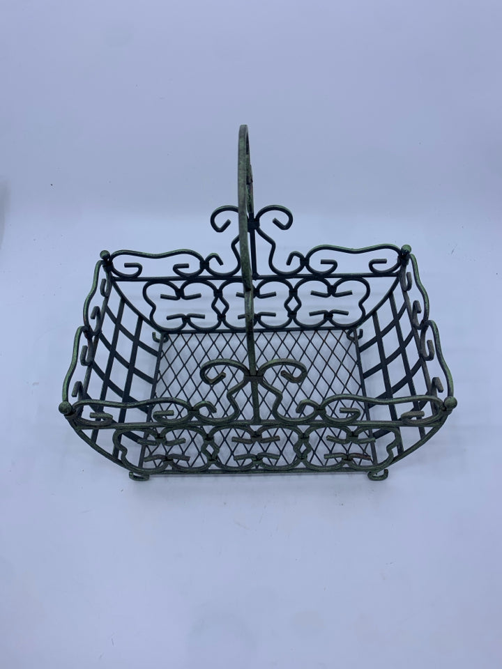 DISTRESSED FOOTED METAL BASKET W/ GREEN TINT SCROLL DESIGN.