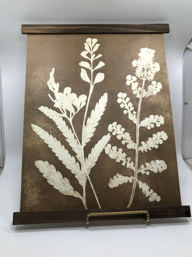 WHITE FLORAL SILHOUETTE ON WOOD WALL HANGING.