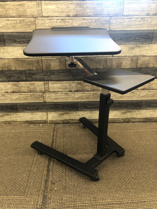 BLACK PLASTIC COMPUTER DESK ON WHEELS.