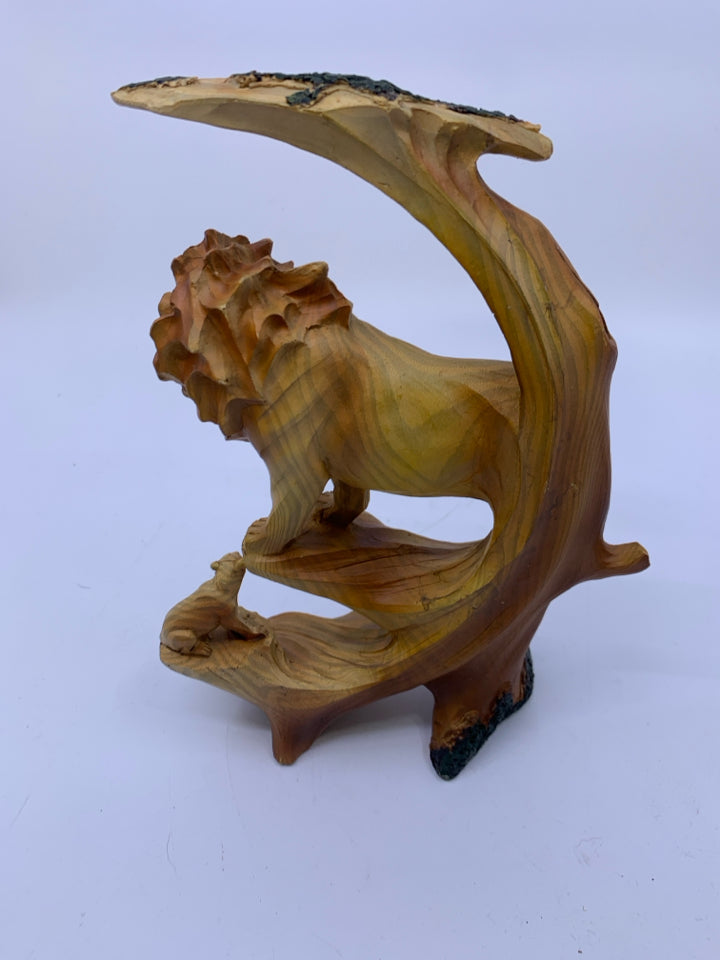 MALE LION ON ROCK COVERED BY TREE W/ LIONESS BELOW CARVED.