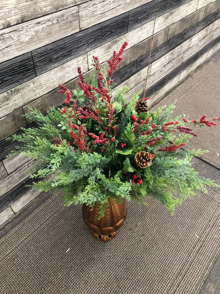 LG ORANGE/BRASS POT W/WINTER FAUX GREENS + PINECONES.