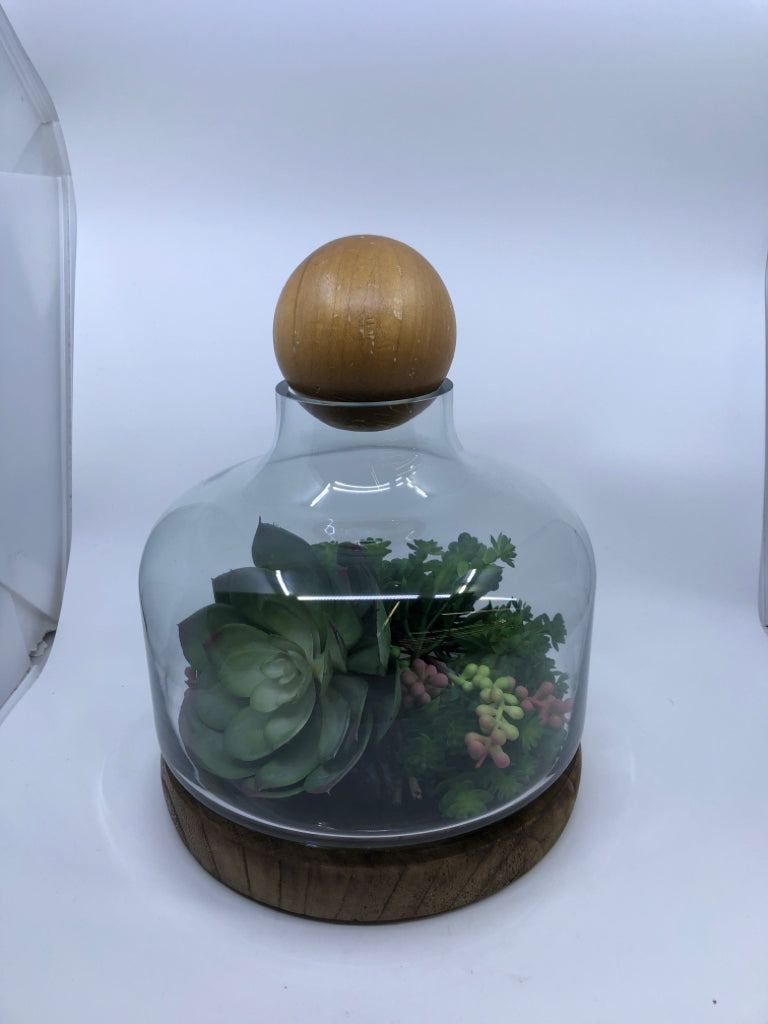 FAUX SUCCULENT TERRARIUM ARRANGEMENT ON WOOD BASE.
