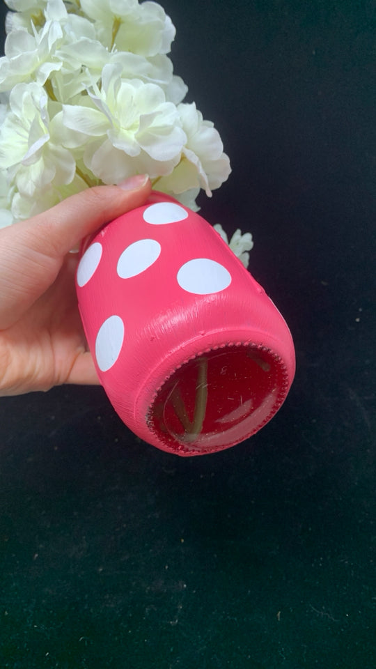 WHITE FAUX FLOWERS IN PINK POLKA DOT JAR.