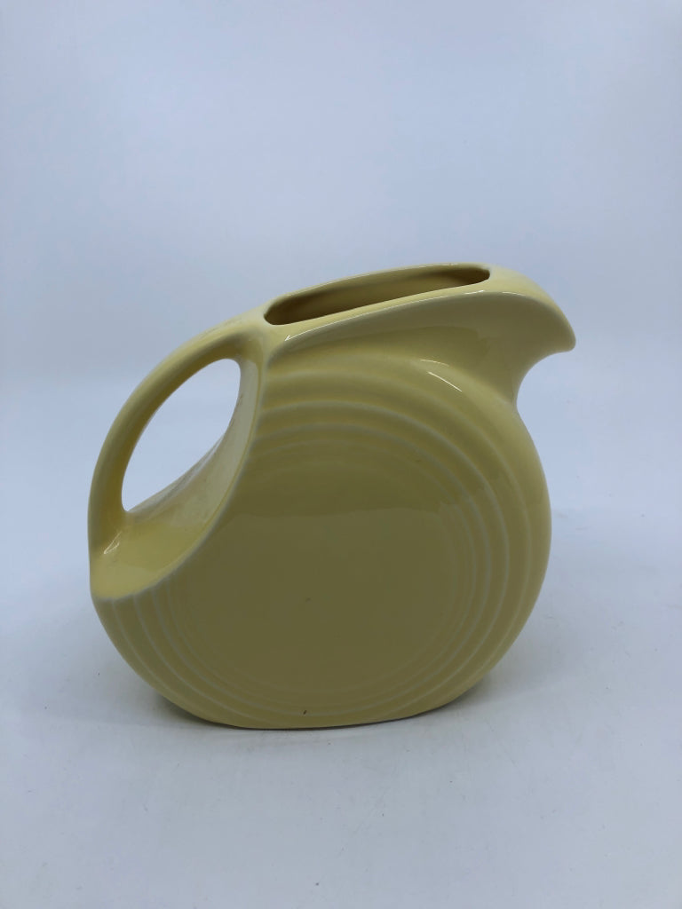 YELLOW FIESTA WARE DISC PITCHER W/HANDLE.