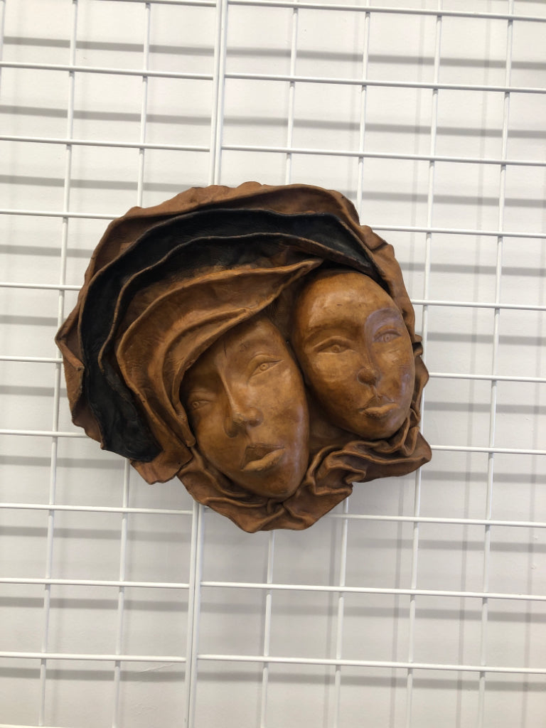 2 EMBOSSED WOMAN FACES MADE OF LEATHER WALL ART.
