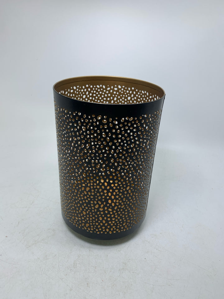 FOOTED METAL PIERCED PILLAR CANDLE HOLDER.