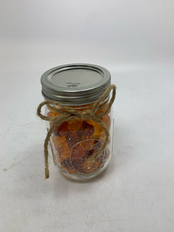JAR OF PUMPKIN BEADS.