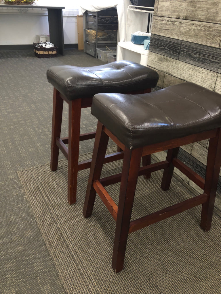 2 BROWN FAUX LEATHER STOOLS W/WOOD LEGS.