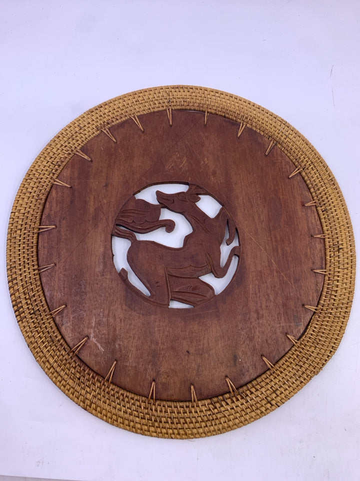 ROUND WOOD TRIVET CARVED ANIMAL DESIGN.