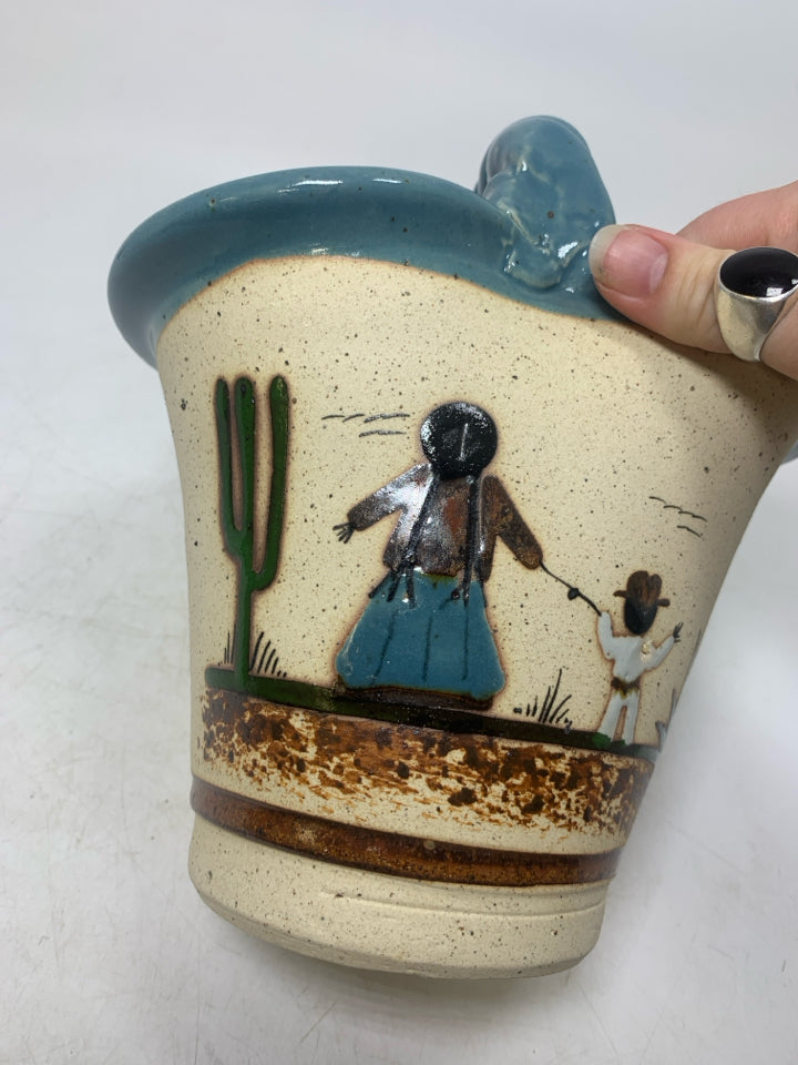BASKET VASE W/ MOTHER/SON HOLDING HANDS LOOKING OUT LIGHT BLUE EDGES.