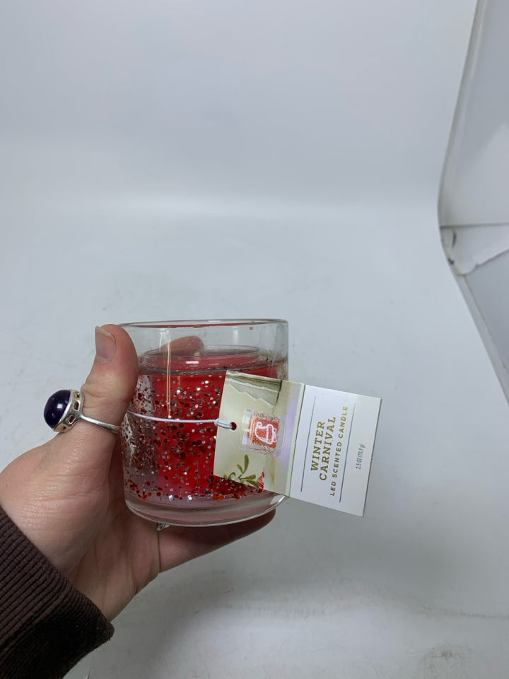 SMALL SANTA THEMED CANDLE.