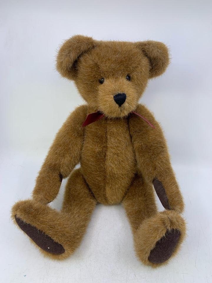 CARMEL COLORED BEAR W/ RED RIBBON.