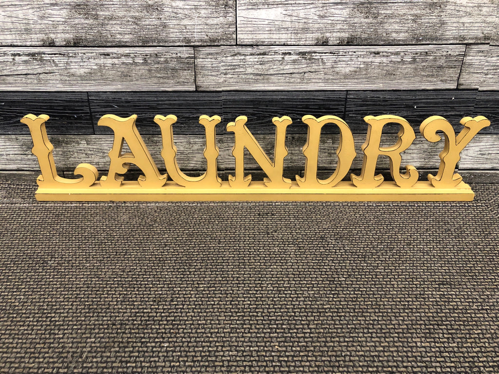 DISTRESSED YELLOW LAUNDRY SIGN.