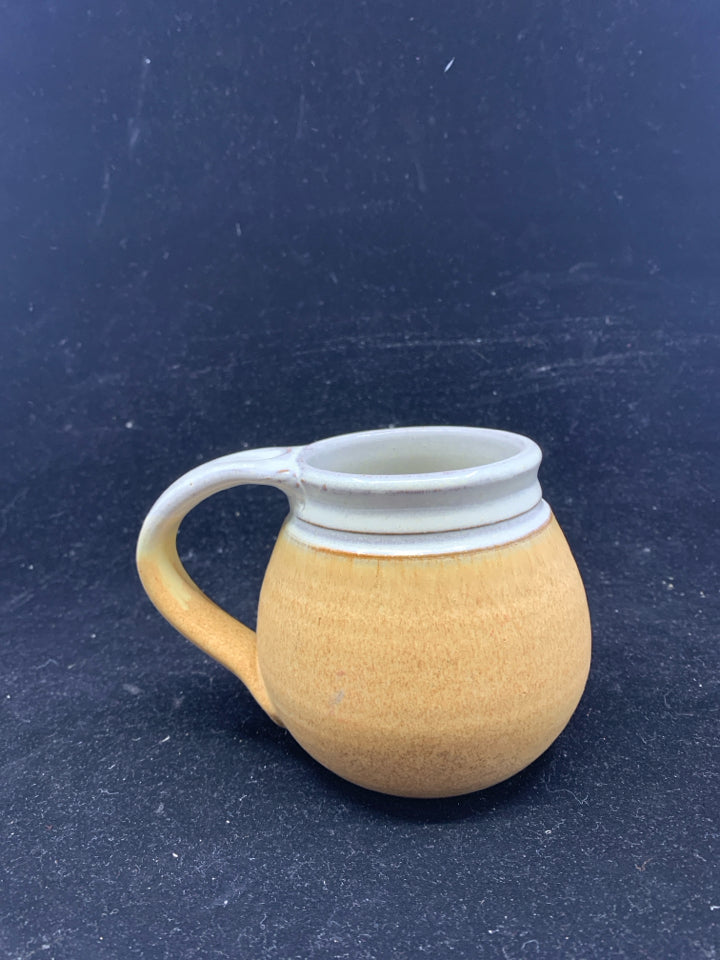 SMALL TAN POTTERY MUG.