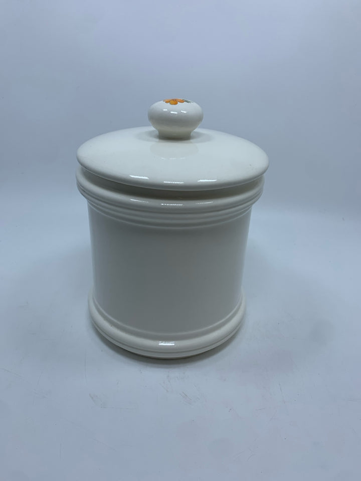 WHITE CERAMIC CANISTER W/BROWN AND ORANGE FLOWERS.
