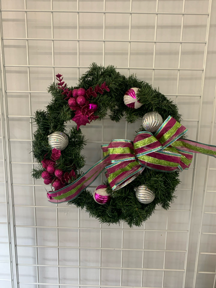 LARGE WREATH W ORNAMENTS AND PINK AND GREEN BOW.