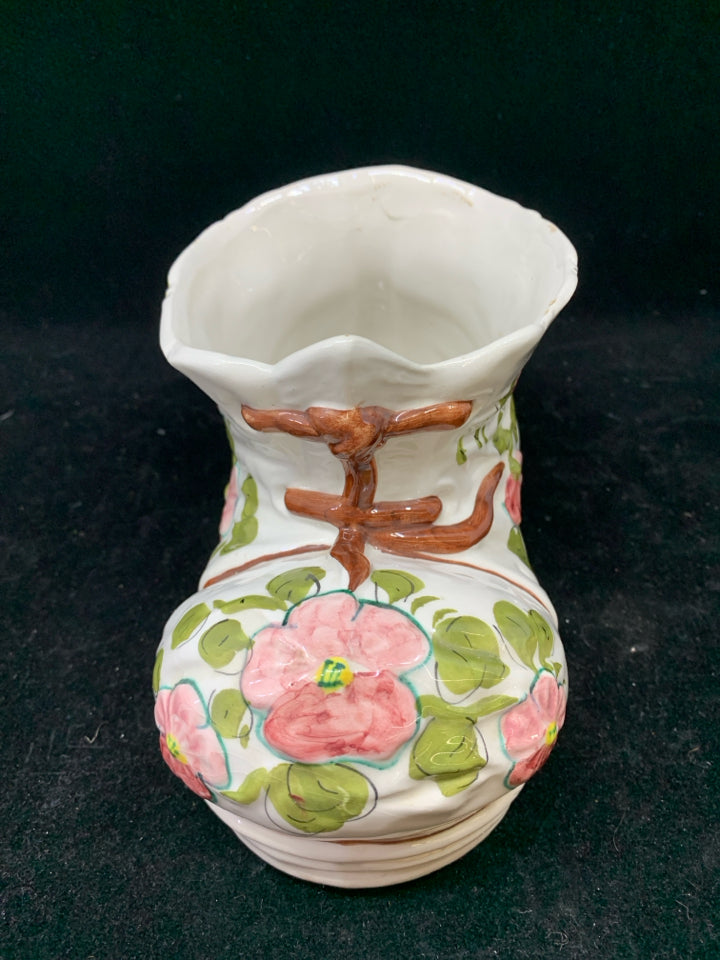 WHITE CERAMIC BOOT PLANTER W/PINK FLOWERS.