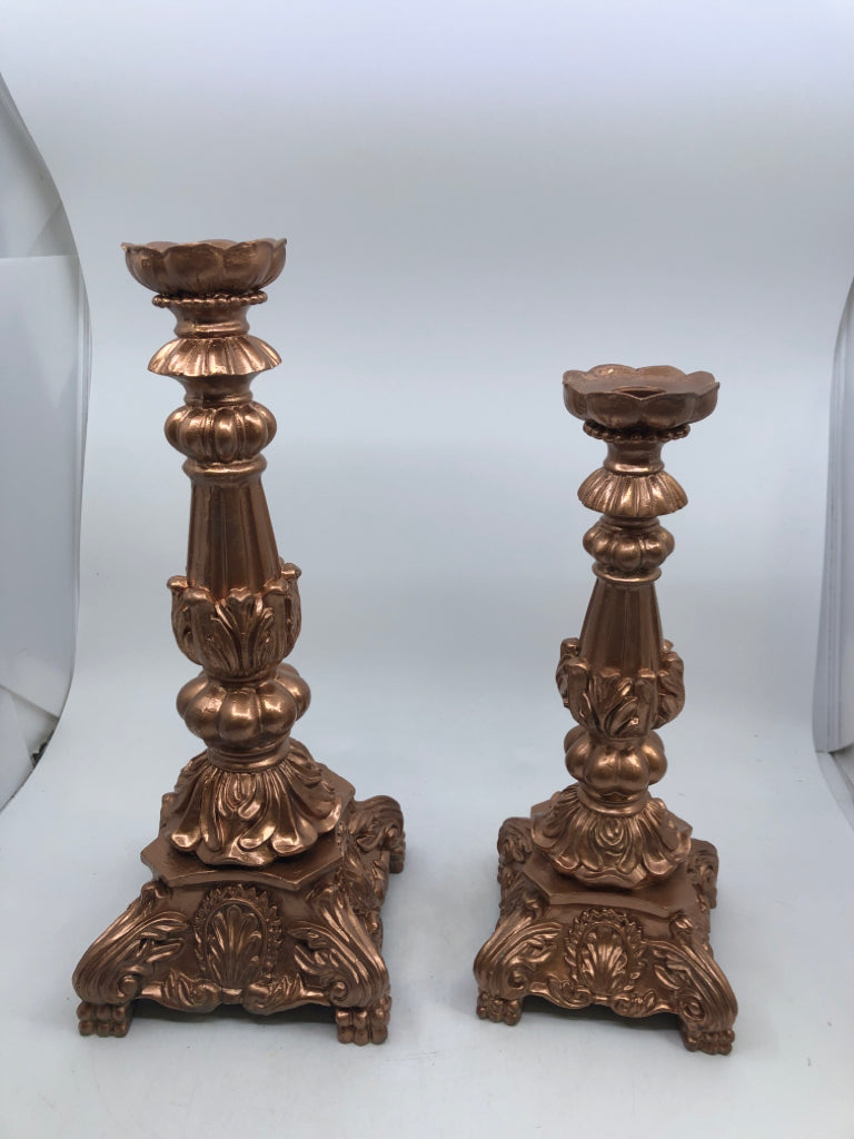 2 ROSE COLORED TAPER CANDLE HOLDERS.