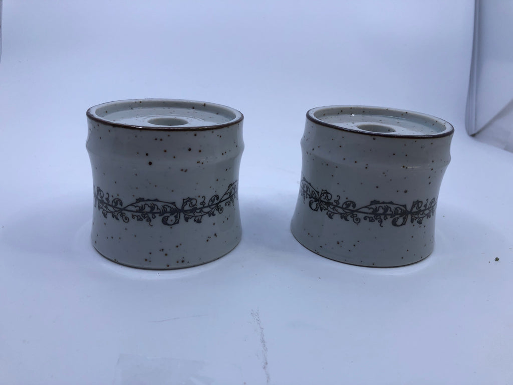 2 WHITE W/ BROWN SPECKLED TAPERED CANDLE HOLDERS W/ SCROLL DESIGN BAND.