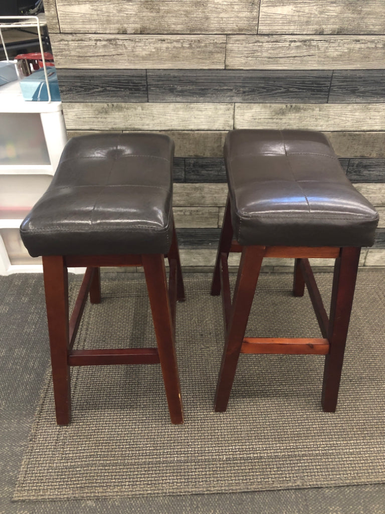 2 BROWN FAUX LEATHER STOOLS W/WOOD LEGS.