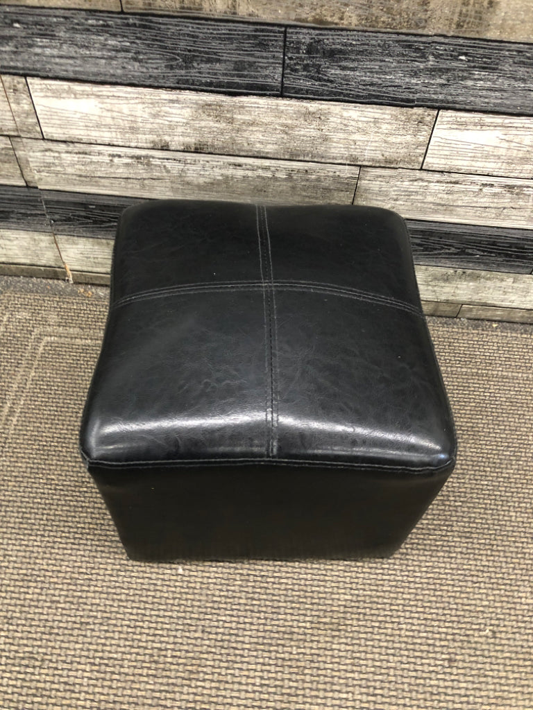 SM BLACK FAUX LEATHER CUBE OTTOMAN.