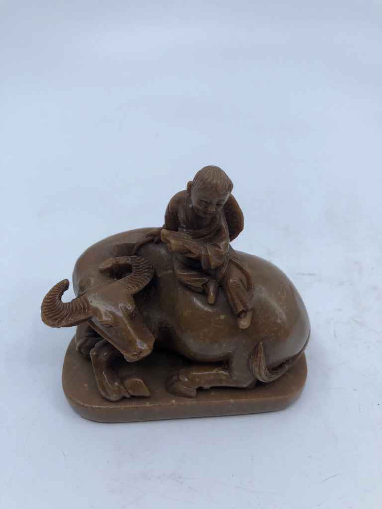 BROWN BULL & MAN FIGURINE ON WOOD SLAB.