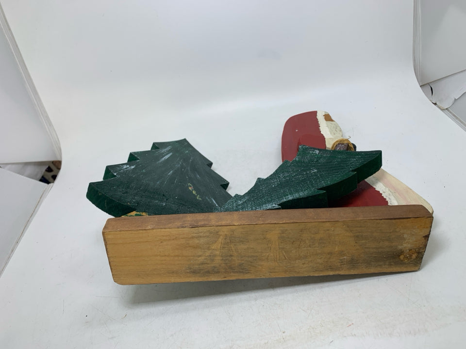 PRIMITIVE WOOD SANTA PULLING TREE.